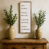 Sit Long Talk Much White sign